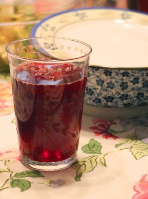 A tall glass of deep ruby-red hibiscus tea